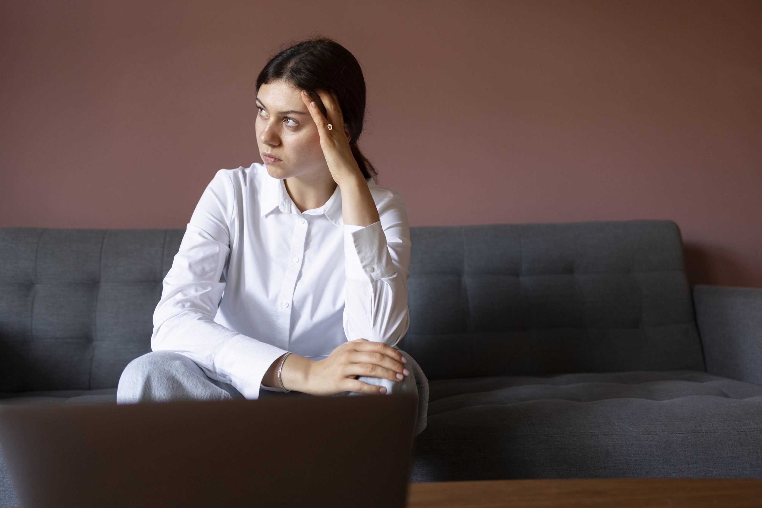 https://psychquility.com/wp-content/uploads/2023/04/front-view-anxious-woman-sitting-couch-1-scaled.jpg